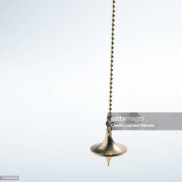 pendulum - hypnosis stock pictures, royalty-free photos & images