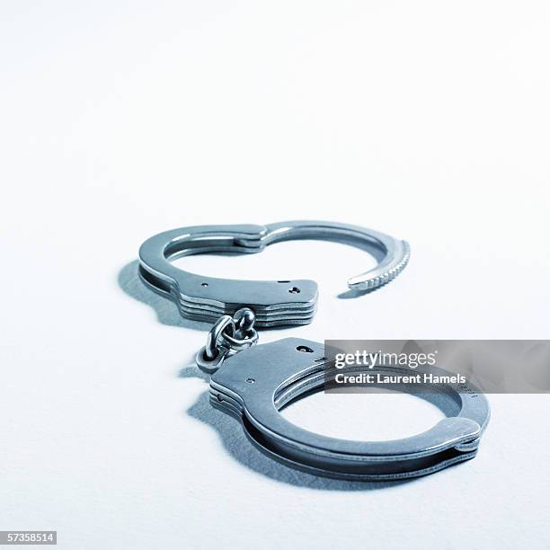 handcuffs - handcuffs stock pictures, royalty-free photos & images