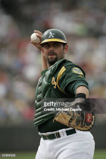 Catcher Jeremy Brown of the Oakland Athletics throws during the Spring Training game against the Chicago Cubs at Phoenix Municipal Stadium on March...