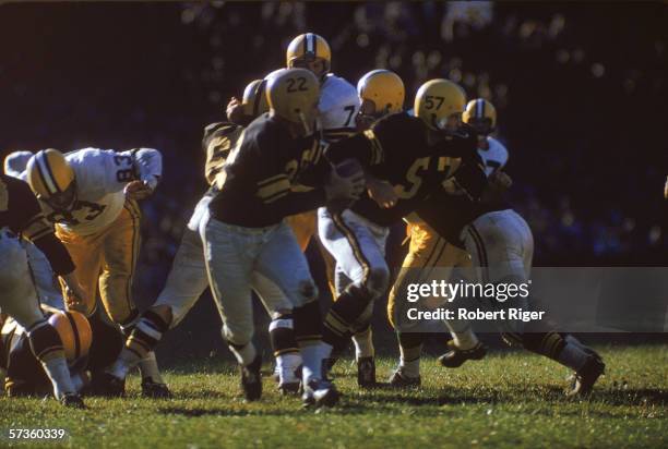 American professional football player Bobby Layne , quarterback fo the Pittsburgh Steelers, drops back to pass during a game against the Green Bay...