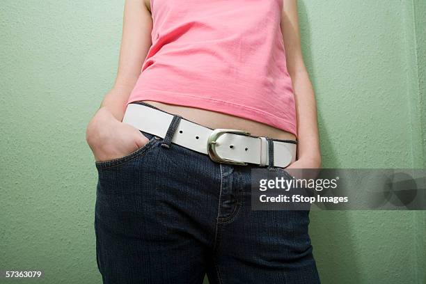 midsection view of young woman in casual clothing - pink belt stock-fotos und bilder