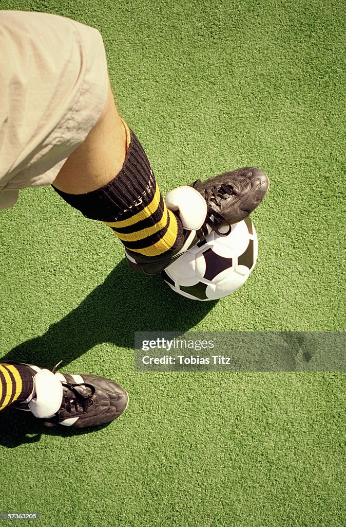 Man with foot on soccer ball