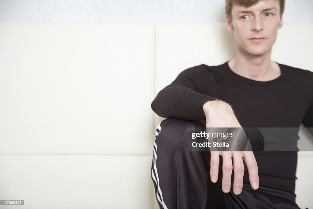 Man sitting on sofa and looking away
