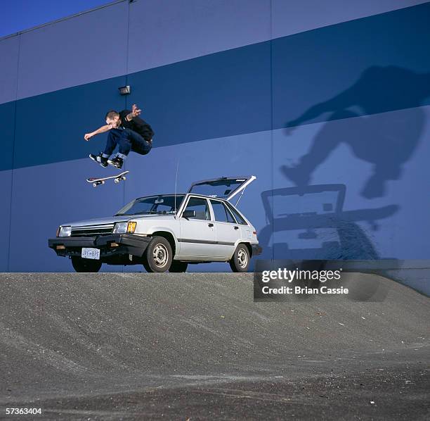 skateboarder doing stunts - car mid air stock pictures, royalty-free photos & images