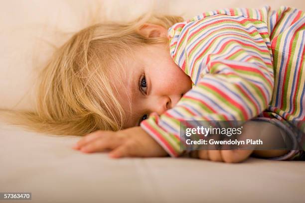 young girl lying down on sofa - one baby girl only bildbanksfoton och bilder