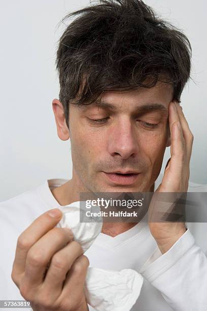 a man with a sinus headache - seno frontal fotografías e imágenes de stock