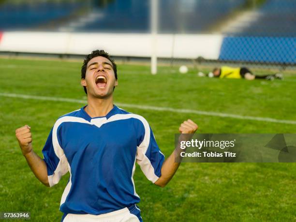 a soccer player celebrating a goal - goal celebration soccer stock pictures, royalty-free photos & images