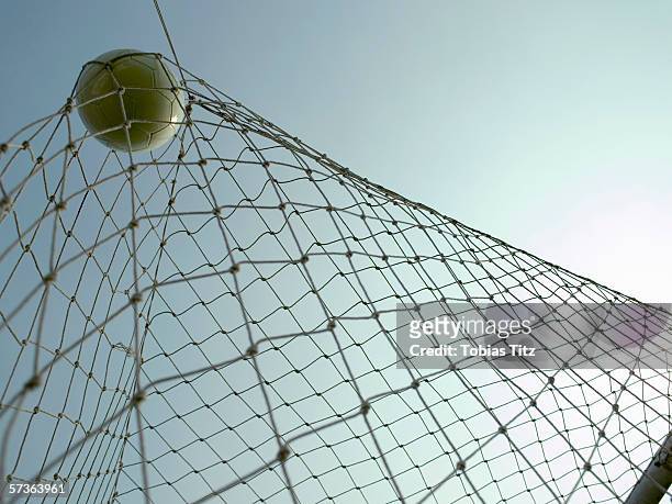 a soccer ball in a goal - good condition stock pictures, royalty-free photos & images