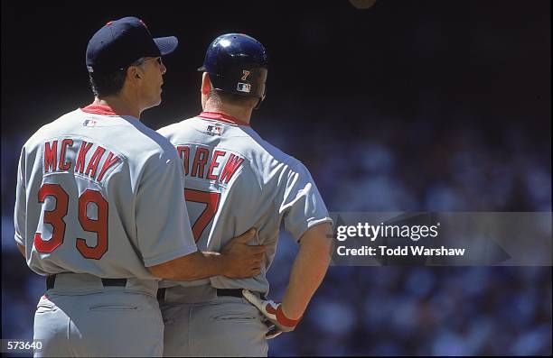 Dave McKay of the St. Louis Cardinals pats teammate J. D. Drew during the game against the Arizona Diamondbacks at the Bank One Ballpark in Phoenix,...