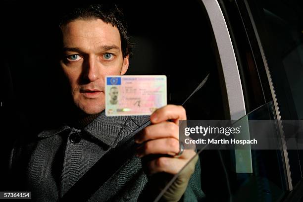 male driver holding his id card - id card stock-fotos und bilder