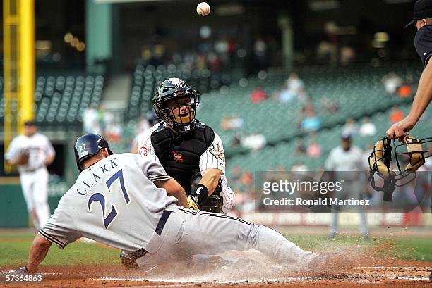Brady Clark of the Milwaukee Brewers slides safely under the attempted tag by Brad Ausmus of the Houston Astros on April 18, 2006 at Minute Maid Park...