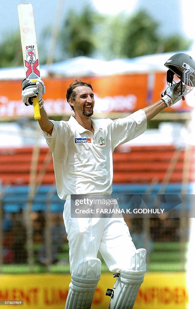 Jason Rai Australian cricketer Jason Gillespie raises his bat and helmet in ...