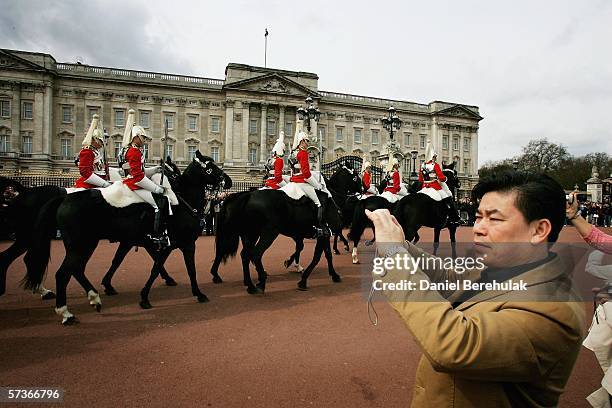 Members of the Queens Guards Household Cavalry ride past Buckingham Palace on April 19,2006 in London, England. TRH Queen Elizabeth II and Prince...