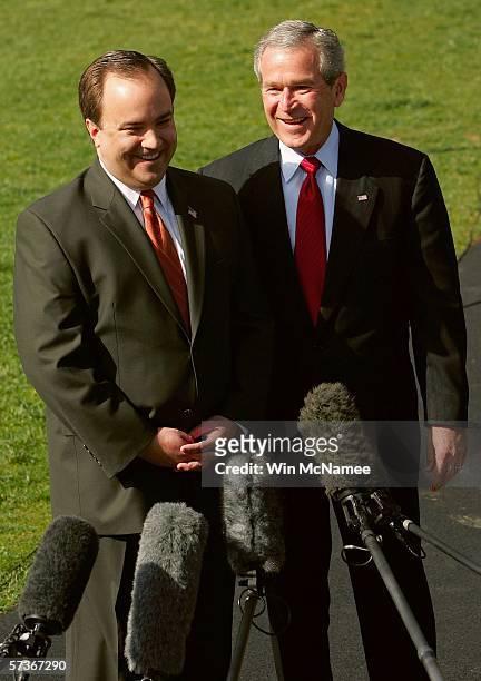President George W. Bush listens as his Press Secretary, Scott McClellan, announces his resignation at the White House April 19, 2006 in Washington,...