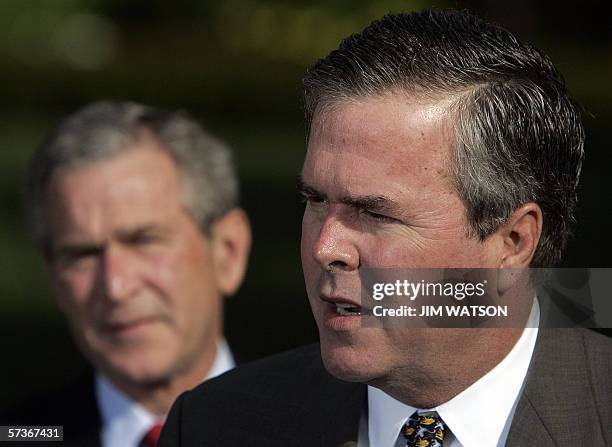 Washington, UNITED STATES: US President George W. Bush looks on as his brother Florida Governor Jeb Bush speaks 19 April, 2006. Governor Bush was...