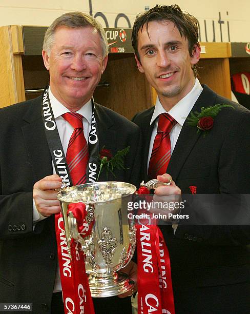 Gary Neville and Sir Alex Ferguson of Manchester United pose with the Carling Cup trophy in the dressing room after the Carling Cup Final match...