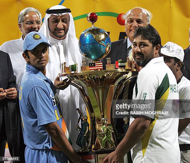 Abu Dhabi, UNITED ARAB EMIRATES: Indian captain Rahul Dravid and Pakistani captain Inzaman-ul-Haq hold together the DLF trophy after their match for...