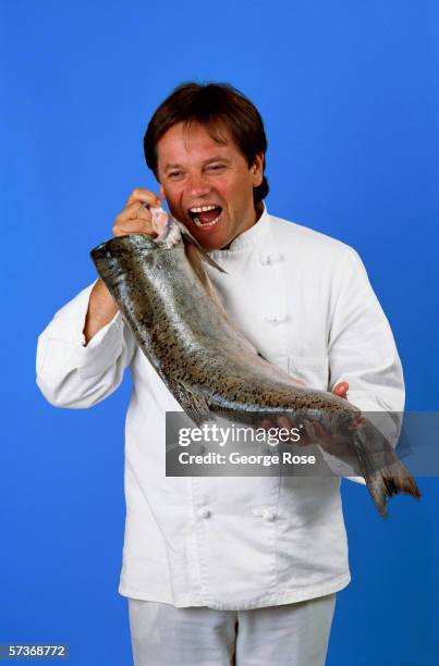 Famed chef Wolfgang Puck clowns around in the studio with a salmon during a 1986 photo session in Beverly Hills, California. Puck is owner of the...