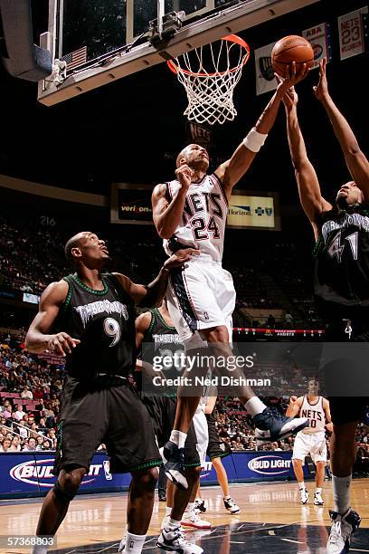 Richard Jefferson of the New Jersey Nets goes to the basket against Eddie Griffin and Justin Reed of the Minnesota Timberwolves on March 23, 2006 at...