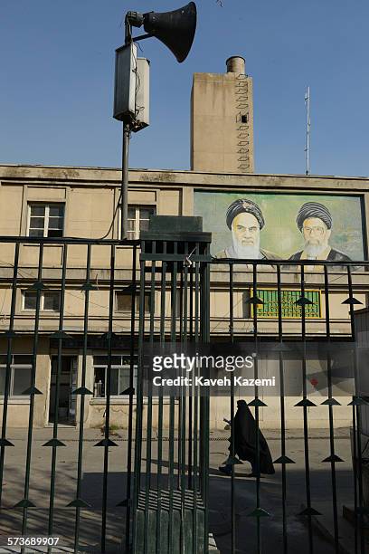 Female student in black chador passes by the building of Basij Mobilisation Resistance Force at Tehran university where Ayatollah Ruhollah Khomeini...