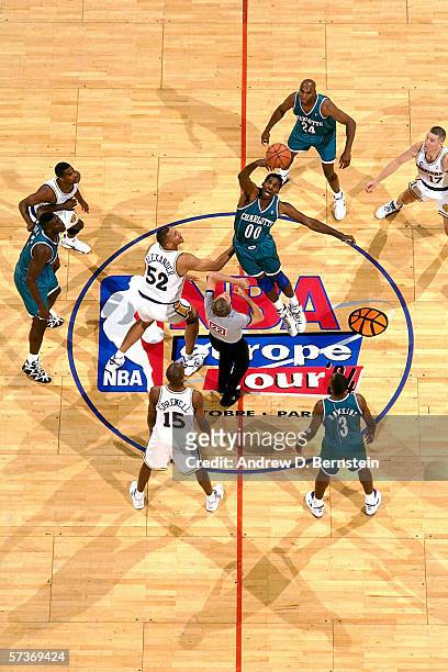 Robert Parish of the Charlotte Hornets jumps for the tip off against Victor Alexander of the Golden State Warriors during a 1994 Exhibition Game...
