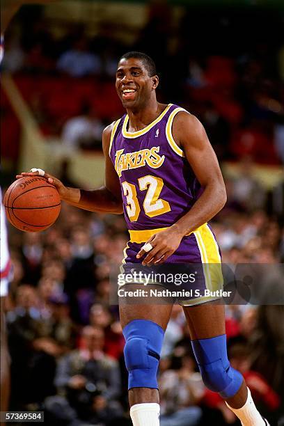 Magic Johnson of the Los Angeles Lakers moves the ball up court during a game against the New York Knicks circa 1990 at Madison Square Garden in New...