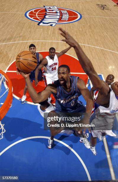 Gilbert Arenas of the Washington Wizards drives for a layup against Amir Johnson of the Detroit Pistons at the Palace of Auburn Hills on April 19,...