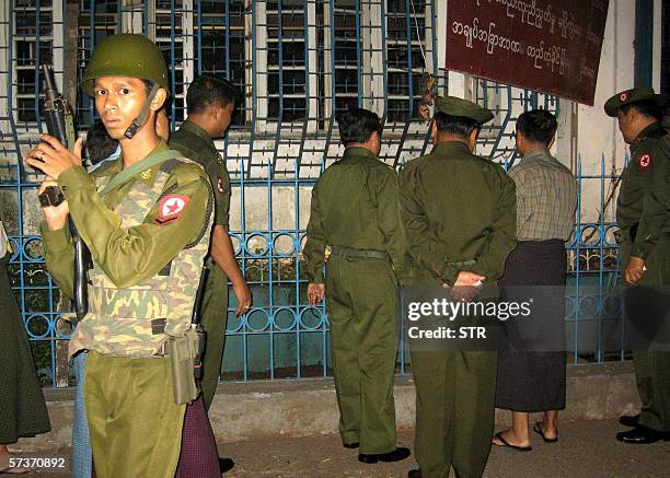 Myanmar soldier provides security to visiting military officials at a site of a bomb blast in downtown Yangon, 20 April 2006. Five small bombs...