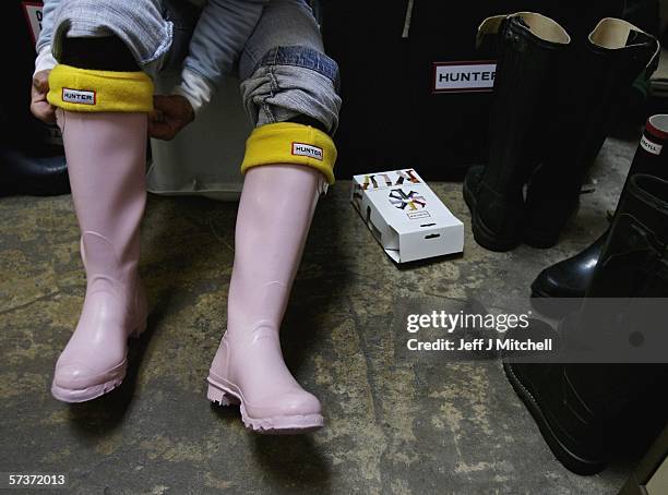 Woman is seen trying on a pair of Hunter wellington boots at the factory shop on April 20 in Dumfries, Scotland.The iconic wellington boot company...
