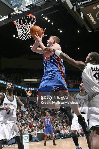 David Lee of the New York Knicks goes to the basket against Justin Reed of the Minnesota Timberwolves during the game at Target Center on March 26,...