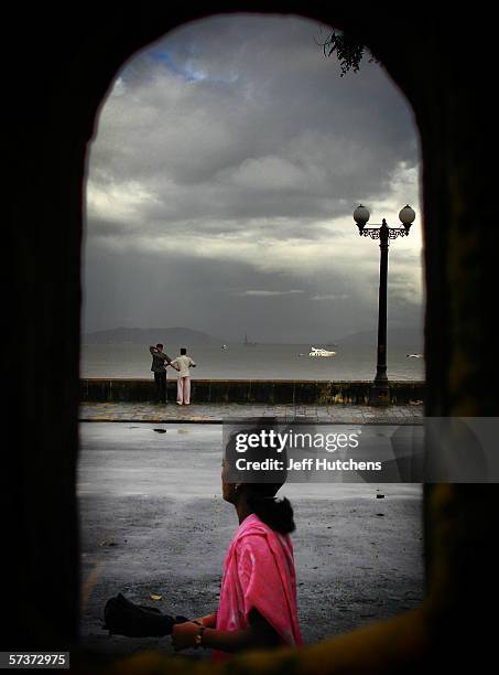 Women looks down the road on September 09, 2005 in Mumbai, India. Emerging from one of the most deadly monsoon seasons in recent history, daily life...