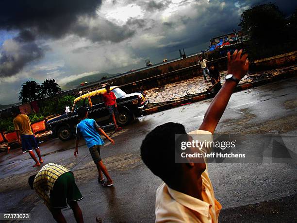 Children play a game of cricket in the streets on September 10, 2005 in Mumbai, India. Emerging from one of the most deadly monsoon seasons in recent...