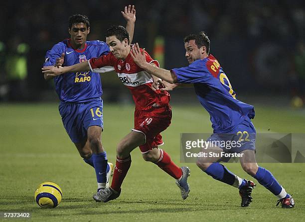 Middlesbrough winger Stewart Downing takes on Benel Nikolita and Sorin Paraschiv during the UEFA Cup semi- final first leg between Steaua Bucharest...