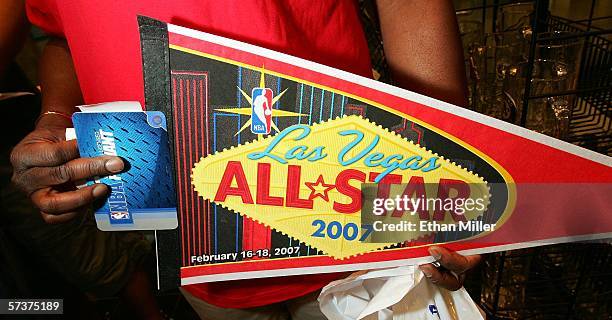 Larry Edwards of Nevada holds a pennant with the logo for the 2007 NBA All-Star Game at the Front Row Sports store at the Fashion Show Mall April 20,...