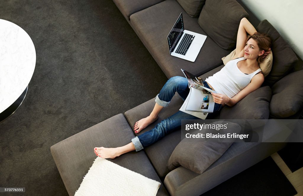 Woman relaxes at home reading