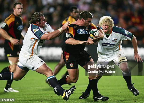 Nathan White of the Chiefs is tackled by Jannie Du Plessis of the Cheetahs during the Round 11 Super 14 match between the Chiefs and the Cheetahs at...