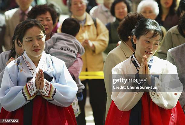 South Korean mothers watch their children as they attend a buddhist ceremony at a Chogye temple on April 21, 2006 in Seoul, South Korea. The children...