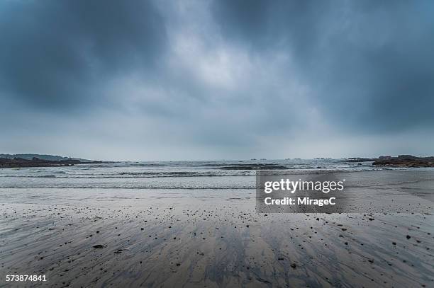 stormy overcast sky and beach in qingdao - overcast stock pictures, royalty-free photos & images