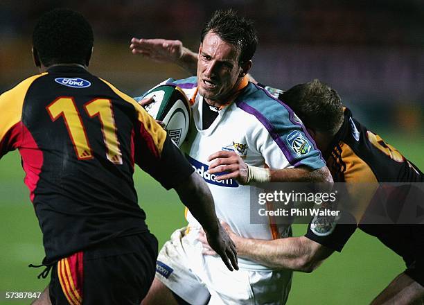 Wilem De Waal of the Cheetahs is tackled by Jamie Nutbrown and Sitiveni Sivivatu of the Chiefs during the Round 11 Super 14 match between the Chiefs...