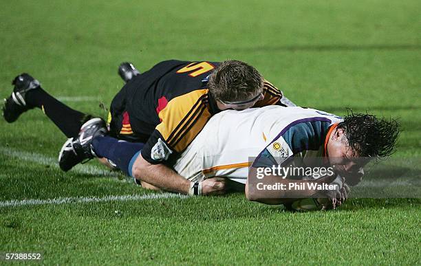 Ollie Le Roux of the Cheetahs scores a try in the tackle of Sean Hohneck of the Chiefs during the Round 11 Super 14 match between the Chiefs and the...