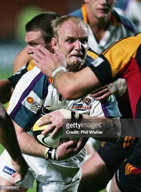 Ryno Van Der Merwe of the Cheetahs is tackled by Nathan White of the Chiefs during the Round 11 Super 14 match between the Chiefs and the Cheetahs at...