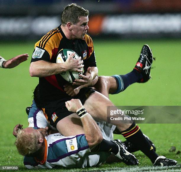Jamie Nutbrown of the Chiefs is tackled by Ryno Van Der Merwe of the Cheetahs during the Round 11 Super 14 match between the Chiefs and the Cheetahs...