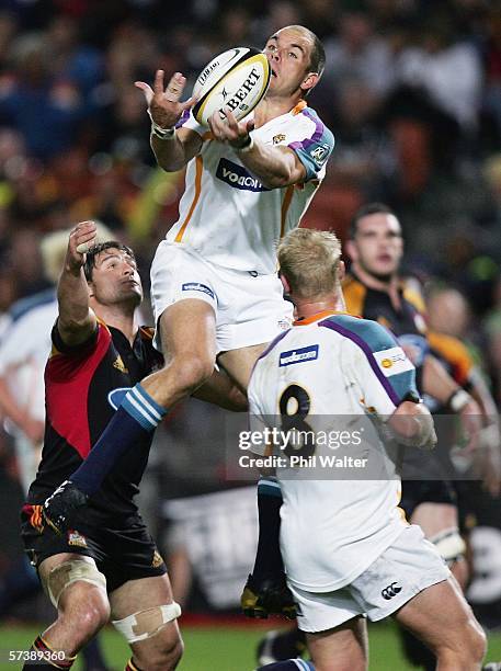 Ryno Van Der Merwe of the Cheetahs takes the high ball watched by Marty Hollah of the Chiefs during the Round 11 Super 14 match between the Chiefs...