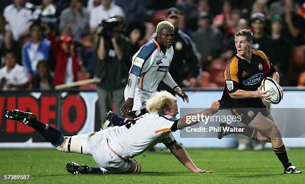 Jamie Nutbrown of the Chiefs is tackled by Kobus Grobbelaar of the Cheetahs during the Round 11 Super 14 match between the Chiefs and the Cheetahs at...