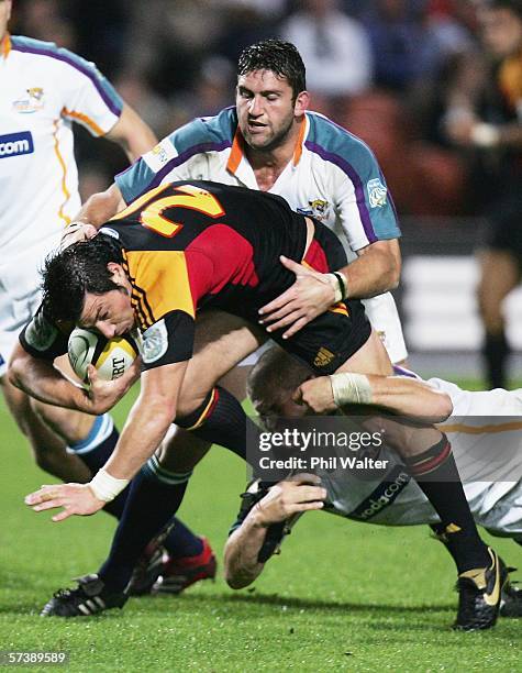 Byron Kelleher of the Chiefs is tackled by Frans Viljon of the Cheetahs during the Round 11 Super 14 match between the Chiefs and the Cheetahs at...