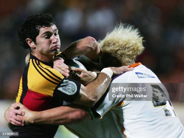 Stephen Donald of the Chiefs is tackled by Kobus Grobbelaar of the Cheetahs during the Round 11 Super 14 match between the Chiefs and the Cheetahs at...