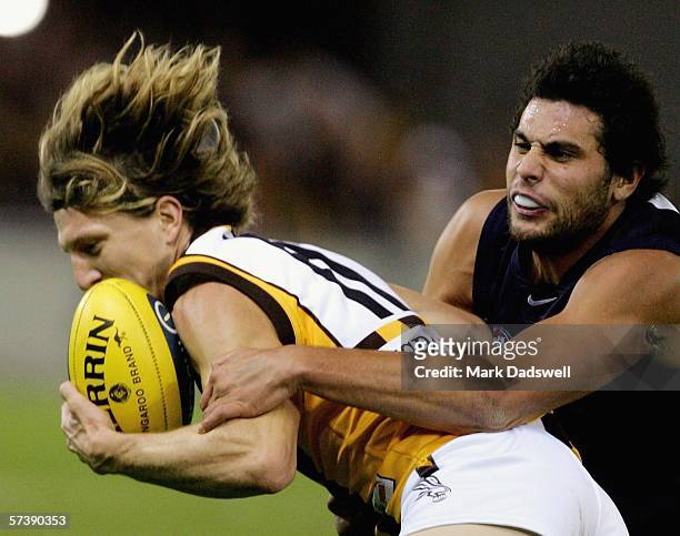 Setanta O"Hailpin for the Blues tackles Joel Smith for the Hawks during the round four AFL match between the Carlton Blues and the Hawthorn Hawks at...