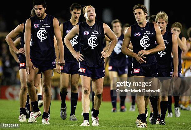 Setanta O'Hailpin, Lance Whitnall and Anthony Koutoufides for the Blues leave the ground dejected after losing the round four AFL match between the...