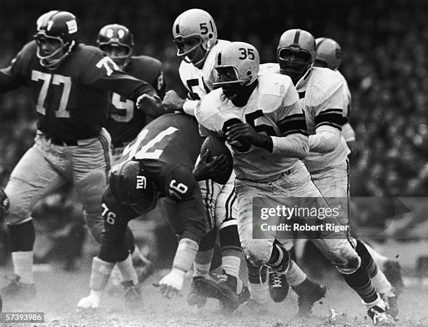 American football player John Henry Johnson of the Pittsburgh Steelers runs with the ball during a game against the New York Giants, early 1960s .