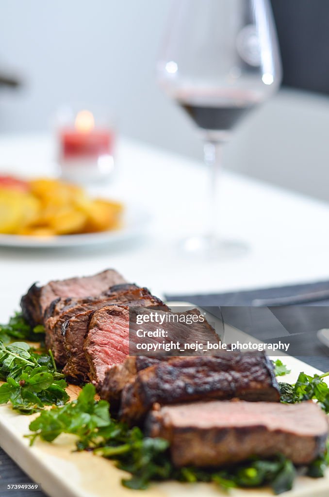 Beef tagliata with a glass of red wine